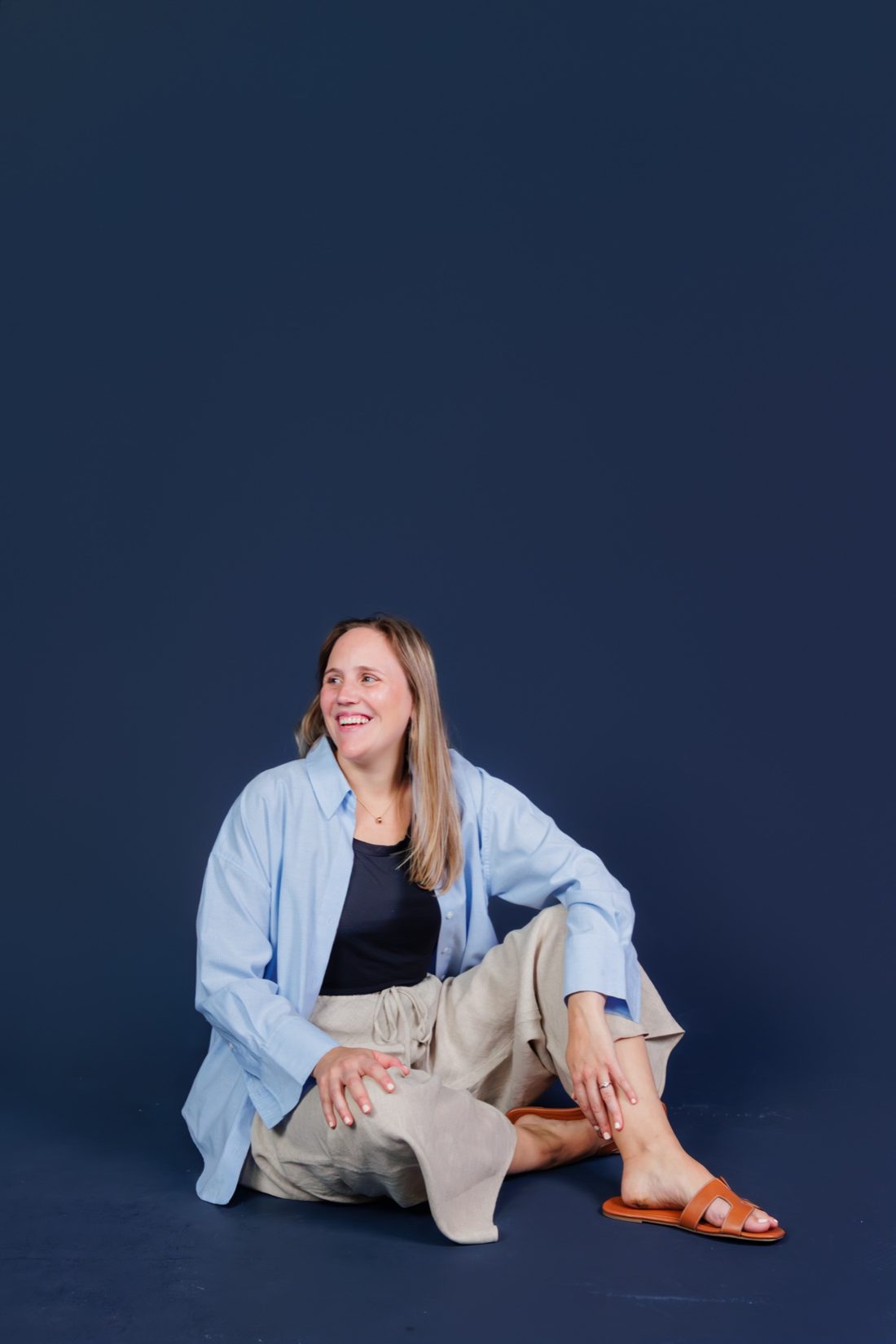 Lucia smiling, sitting on the floor