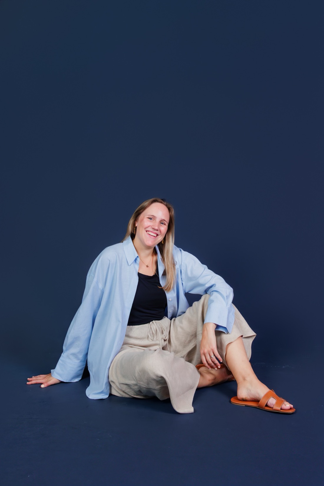 Lucia smiling, sitting on the floor